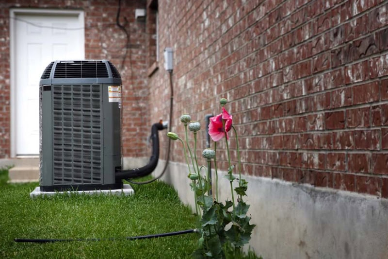 AN Air Conditioner outside on a slab.