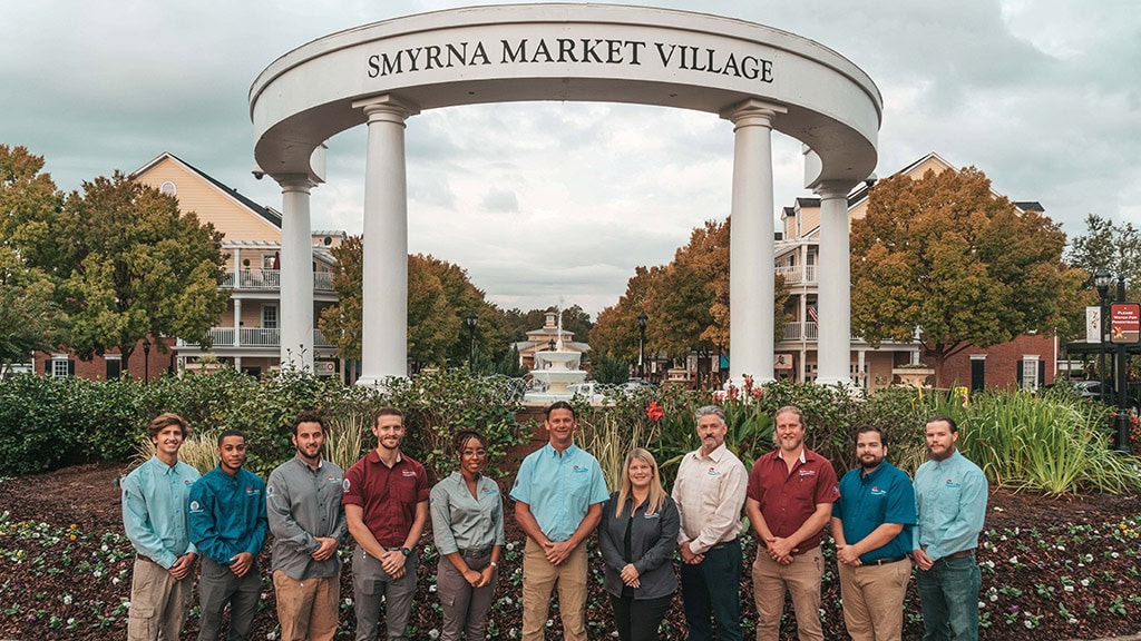 Carter & Sons HVAC team standing in front of the Smyrna Market Village.