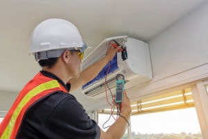 Technician - Engineer investigate Repairing Air Conditioner