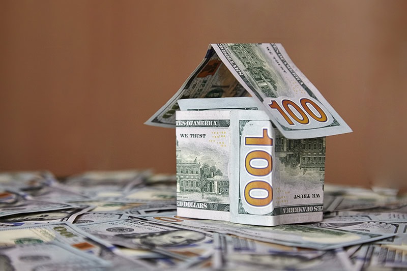 House of money on the background of money, dollar bills the concept of accumulating investing money.