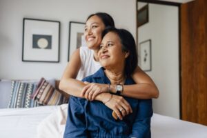 What Are Zone Control Systems? The love between a mother and daughter is forever: a smiling Asian female embracing her mother while they are looking away.